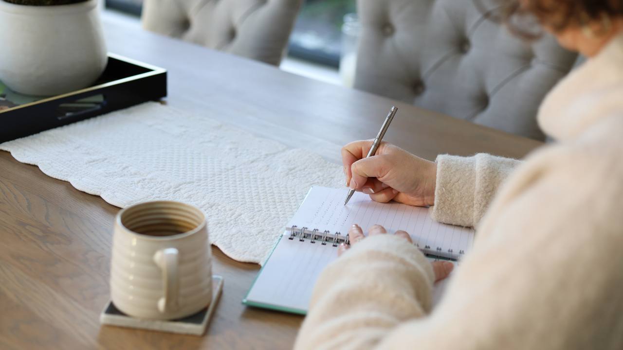 Laura Andrews at table writing